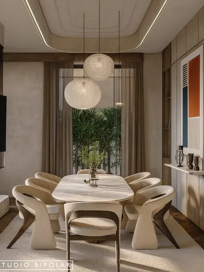 The dining space is illuminated by beautiful pendant lights that add a soft, ambient glow. The curved lines of the ceiling detail, chairs, and table create a harmonious and visually pleasing composition.