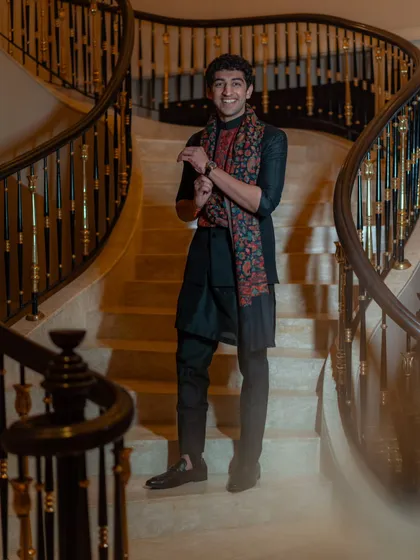 For an evening event, we styled the brother of the bride in a dark kurta set, elevated with a beautifully printed shawl. This simple addition adds a touch of color and sophistication, perfect for a sangeet or reception.