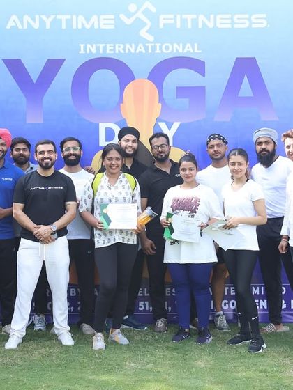 Members and trainers posing with their certificates after our International Yoga Day event. We believe in recognizing participation and effort.