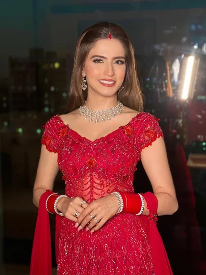 A happy, smiling bride ready for her reception party. The makeup is glamorous yet feels light, allowing her to feel comfortable and beautiful.
