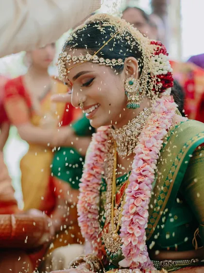 The pure joy of a wedding ceremony. This candid moment captures my South Indian bride, Meghna, during her Mahuratham in Coorg. Her makeup was designed to be luminous and long-lasting, with defined eyes that sparkle with happiness, even through the most emotional rituals.