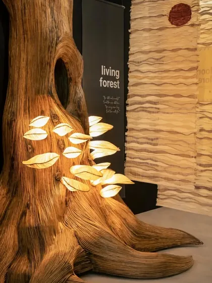 A detailed shot of the 'Living Forest' tree installation. The texture of the trunk and the soft light from the mushroom lamps created a focal point that was both interactive and educational. We explained how the material, Lantana, is an invasive weed, making the installation a story of ecological redemption.