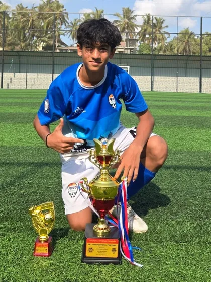 This U14 player shows off both his team trophy and individual award.