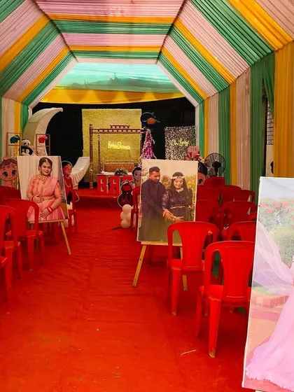 The entrance walkway of a baby shower, lined with the couple's maternity photos on easels for a personal touch.