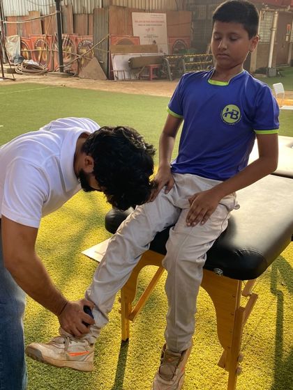 A physio works on a player's leg on a therapy table. Hands-on treatment and recovery support are integral parts of our high-performance program.