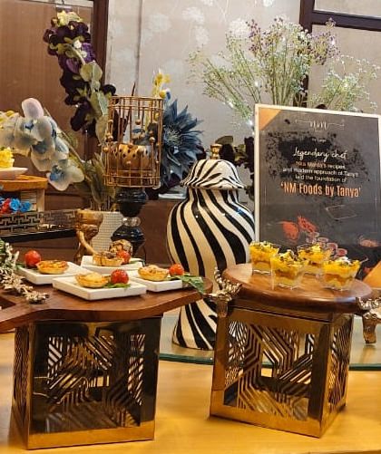 This showcases our ability to integrate branding and decor into our grazing tables. The setup includes custom signage and decorative elements that align with the event's theme, like these stylish zebra-print vases.