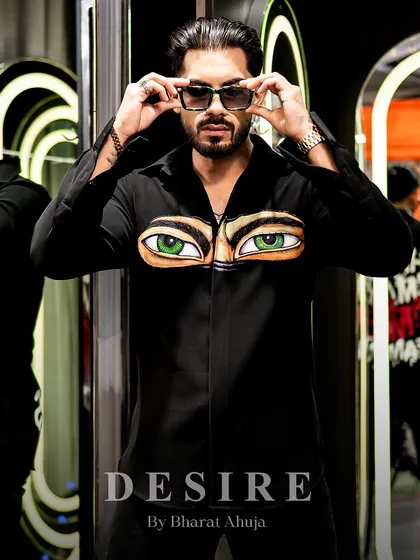 A powerful, direct-to-camera pose in the 'Haters' eyes shirt. This is fashion that stares back.