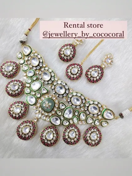 A stunning Meenakari necklace with red and green accents. This rental piece is perfect for someone who wants a traditional yet not fully bridal look.