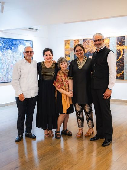 A group photo from the opening night of 'Call to the Mystic,' featuring the artist Eva Malhotra, our founder, and guests.