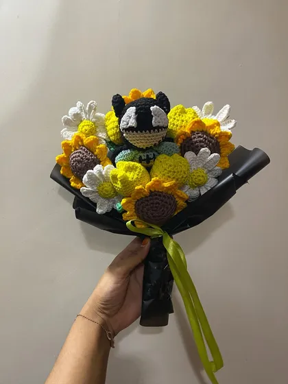 A clear, well-lit photo of the Batman bouquet, showing the texture of the yarn and the careful arrangement of each handmade flower.