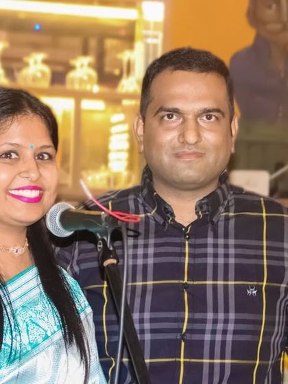 A couple posing for a photo at a restaurant event. I am experienced in shooting in various indoor venues.