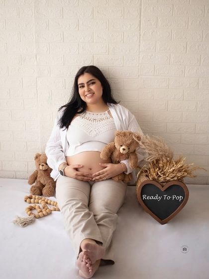 A fun and relaxed solo shot with props like teddy bears and a "Ready To Pop" sign, adding a touch of humor to the casual session.