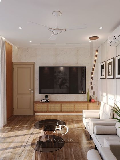 This living room combines a modern aesthetic with rustic touches, featuring a TV mounted on a marble-finish wall, a cane-front media unit, and warm wooden flooring.