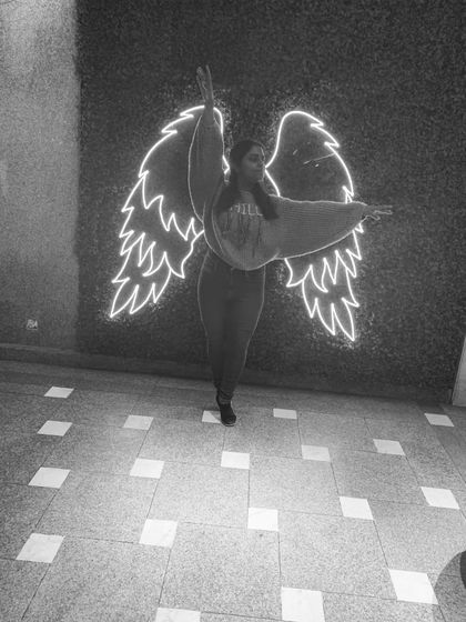 Posing with these neon wings because dance truly makes you feel like you can fly. It's an expression of freedom and joy.