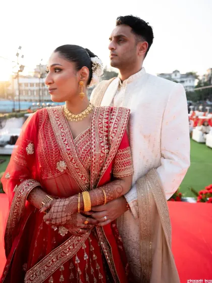 A candid moment during the couple's portrait session, capturing a natural interaction against the backdrop of their wedding venue.