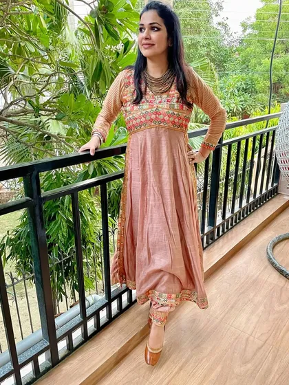 An old saree with beautiful embroidery on the pallu was repurposed into this elegant Anarkali suit. We used the embroidered part for the yoke and the border for the pants.
