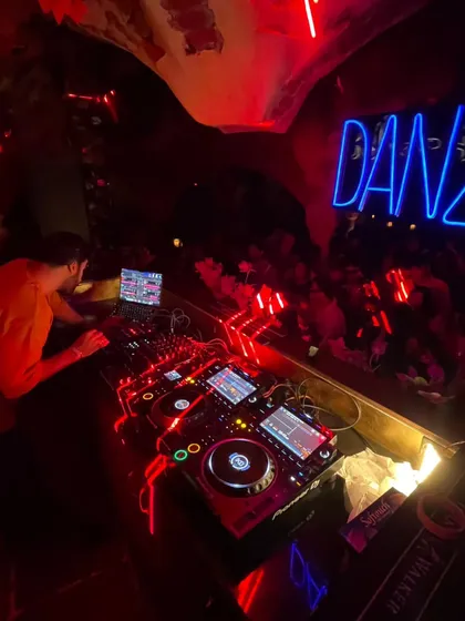 In the zone at Danza, surrounded by neon lights and a crowd that's ready for a journey. I love playing in spaces with a unique, immersive atmosphere like this.