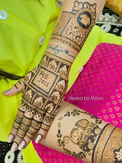 A closer look at the personalized elements in this baby shower mehendi. One arm features a baby in a pram, while the other has a cute drawing of a house.