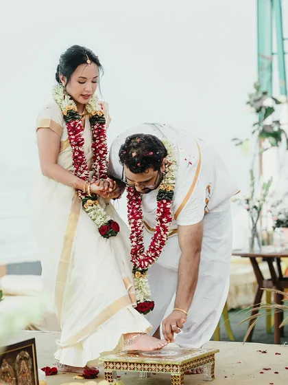Documenting a traditional South Indian wedding ritual by the beach. The groom places the ring on the bride's toe, a moment of gentle respect and commitment we capture with care.