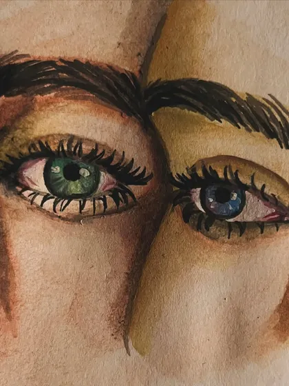 An expressive watercolor painting of two different colored eyes. This is a piece from my personal sketchbook where I explore color and emotion.
