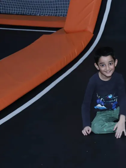 Taking a quick break from all the jumping. Even a moment of rest is full of smiles at our expansive and fun-filled trampoline park.