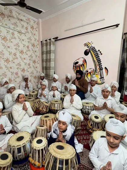 My 'students of the month' sitting with folded hands after a devotional music session. This photo reflects the discipline and respect we cultivate at the academy.