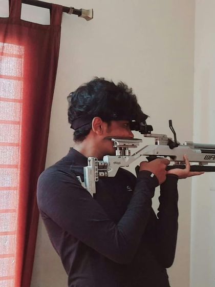 A shooter practices his form at home. We provide our athletes with dry fire and home practice routines to ensure they can continue to hone their skills even when they are away from the range.