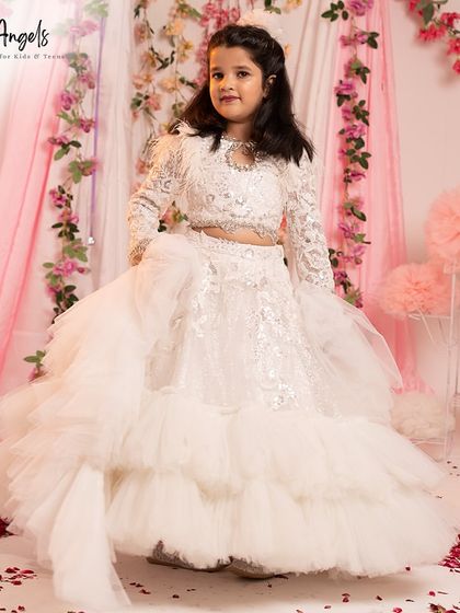 Pictured against a festive backdrop, this white lehenga with its voluminous skirt is an ideal choice for a special celebration.