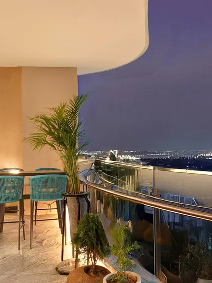 This spacious balcony at The Amaryllis, New Delhi, was designed as a serene escape with a stunning city view. We created a comfortable and stylish outdoor seating area, perfect for evening relaxation, seamlessly extending the home's living space into the open air.