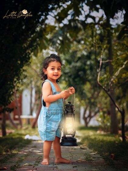 Lighting the way. Using props like this vintage lantern adds a touch of storytelling and adventure to our outdoor toddler sessions.