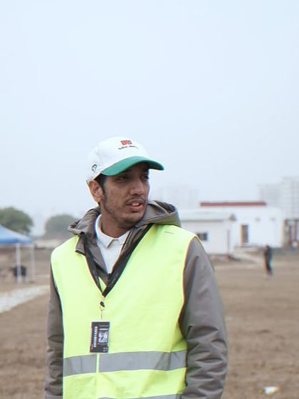 On site at a flying field, wearing a safety vest and keeping my eyes on the prize. Every flight requires focus and preparation.