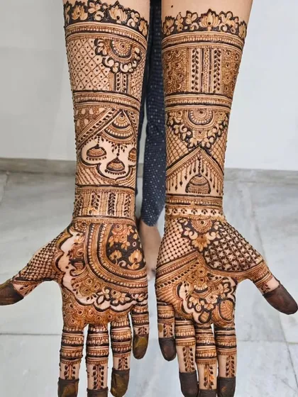 Another look at this full-arm design, showing how the patterns wrap around the arm. The hanging 'jhumka' motifs add a touch of grace and movement to the overall design.