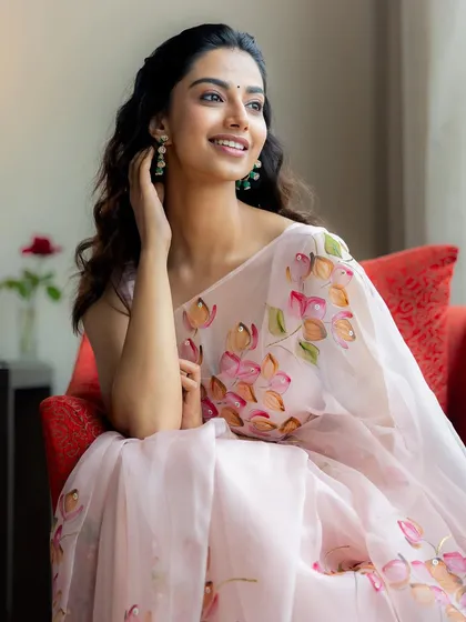 A duplicate of image 1, this shot showcases the delicate details of the floral saree and the model's happy expression, a key part of my people-focused creative direction.
