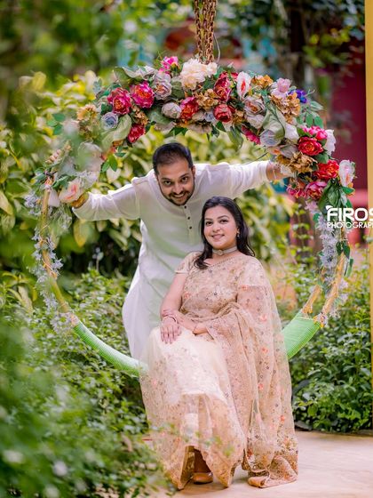 A playful and happy couple on our floral swing, a perfect spot for a fun and romantic photo.