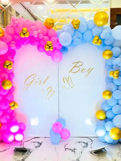 Building excitement for a gender reveal party with this "Girl or Boy?" backdrop. We use distinct pink and blue balloon arches that meet at the center, accented with gold balloons for a touch of elegance, creating the perfect photo opportunity for the big announcement.