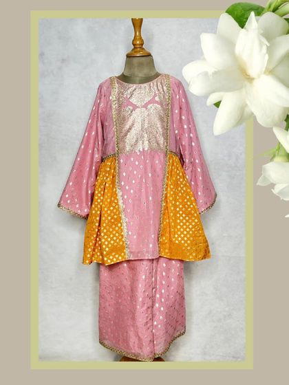 A beautiful peplum-style kurta set from our Mogra collection. The combination of pink and yellow chanderi fabric with zari work is both elegant and comfortable.