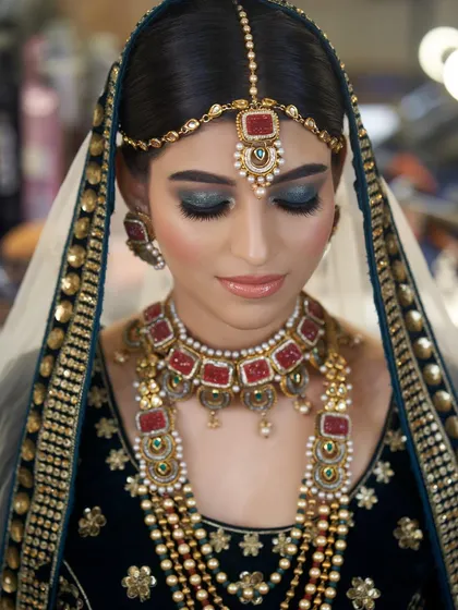 A clearer view of the bride's stunning makeup. The deep teal smokey eye is a bold and beautiful choice against her dark velvet outfit.