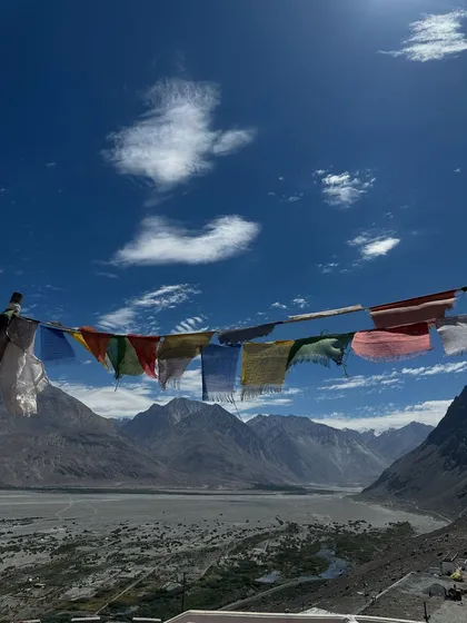 The vibrant prayer flags against the vast, dramatic sky of Ladakh. They are a constant reminder of the spiritual energy that permeates this land, a beautiful symbol of hope and compassion.