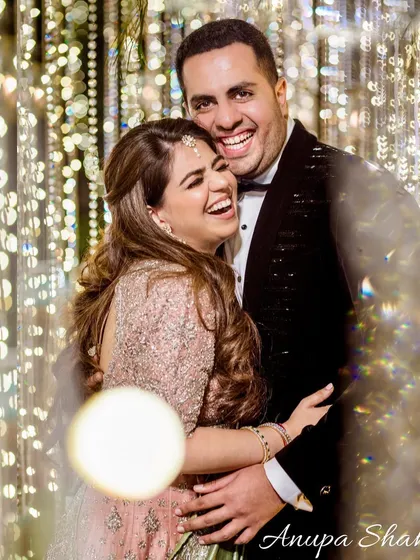 The best moments are the ones filled with genuine laughter. This candid shot from a reception captures the couple's infectious happiness, showcasing the fun and celebratory side of their story.