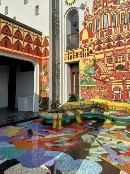 Here, art spills from the walls onto the floor and becomes furniture itself. This residential courtyard in Rajkot features a vibrant, hand-laid floor mosaic and integrated sculptural seating, creating a completely immersive, functional art experience.