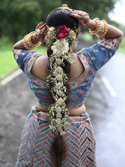A stunning bridal braid adorned with traditional Indian hair jewelry and fresh flowers. This is a popular style for weddings and we teach it in detail.