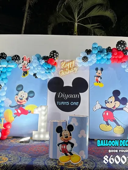 A classic Mickey Mouse theme for a first birthday. The setup uses Mickey's signature colors with character cutouts and a custom backdrop.