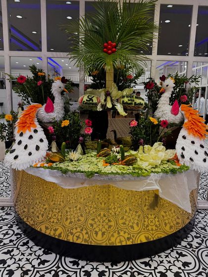 An example of our complimentary vegetable carving service. This intricate display, featuring swans carved from vegetables, adds a touch of artistry and elegance to the buffet or main table setup.