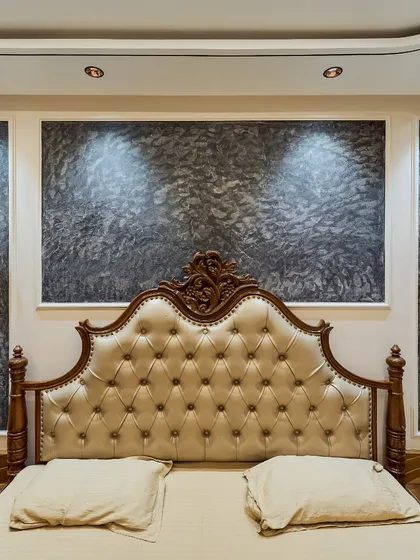 A classic and luxurious master bedroom design. I used a traditional carved bed with a tufted leatherette headboard, complemented by a textured wall panel and elegant wall sconces.