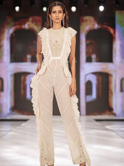 A modern take on ethnic wear. For this ruffled jumpsuit, I created a clean makeup look with defined eyes and styled the hair in soft waves to keep it contemporary and chic.