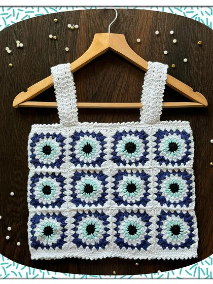 A closer look at my popular evil eye granny square top. Each square is carefully crocheted and joined to create this unique protective pattern. It's a fun, modern take on a classic crochet style.
