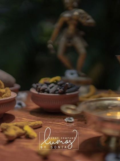 Another detailed shot of the Haldi ingredients, with a blurred background of a traditional brass statue.