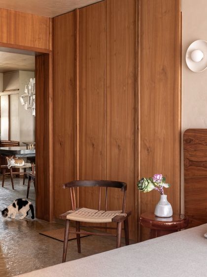 This view from the bedroom into the living area shows how the open design allows pets to move freely and be part of the family's activities. The consistent use of wood creates a unified, warm environment.