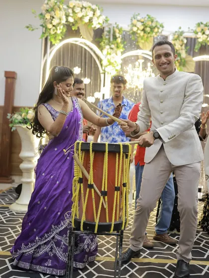 It's always fun to mix in live elements. Here, the guests are having a blast with a traditional drum during the sangeet, adding a unique and personal touch to the celebration.