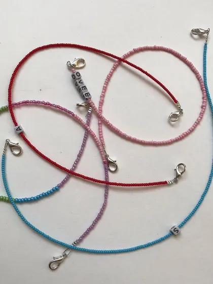 These are my versatile, personalised beaded chains. They can be used as a stylish mask chain or worn as a choker necklace, with custom initials or names.
